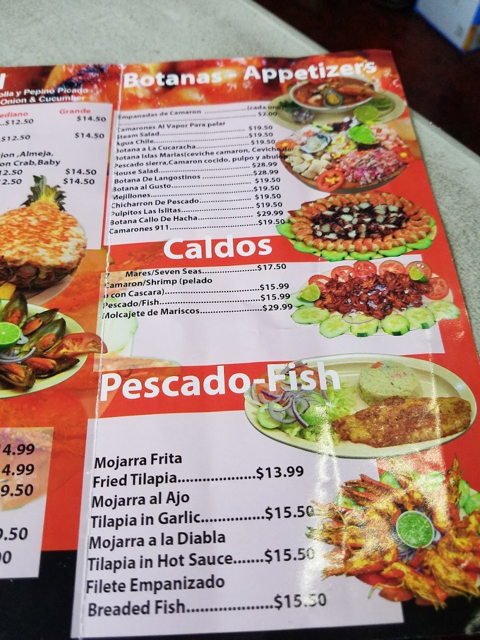 Printed menu with seafood and cocktail sections.